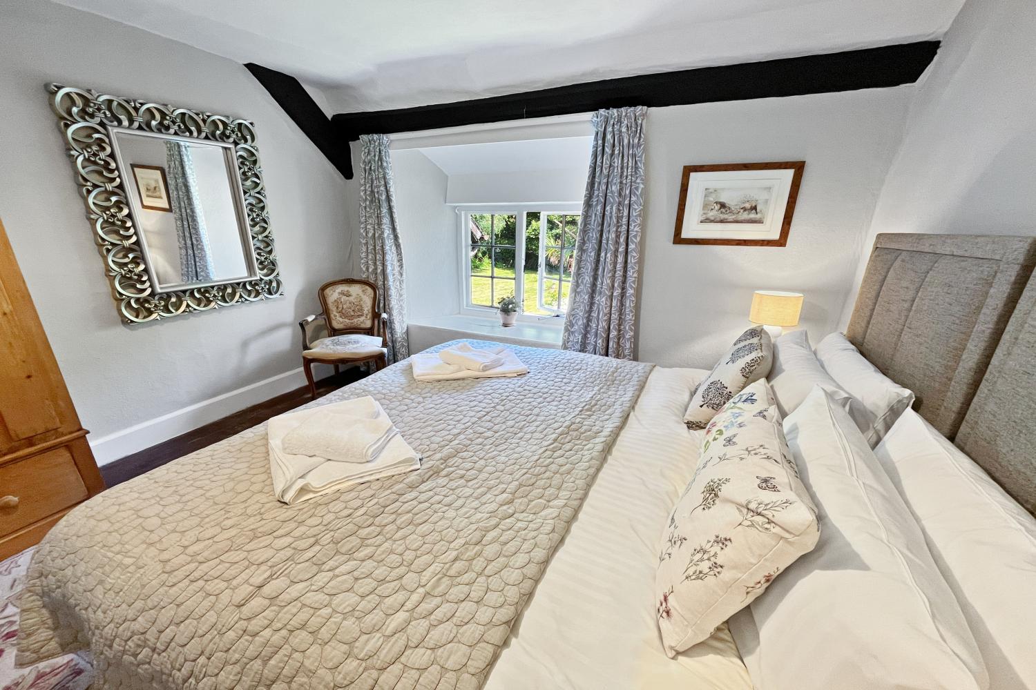 Bedroom 2 looking out into front garden, view of Bossington Hill