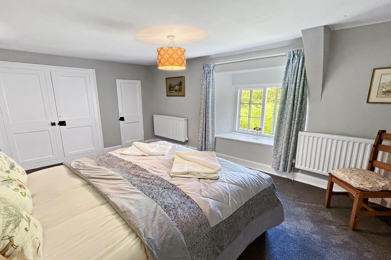 Bedroom 1 (double looking out into front garden, view of Bossington Hill)